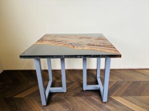 スモーキーグレーのレジンとブラックウォルナット材を使用した850mm角レジンテーブル。グレーのアイアン脚がシンプルな構造で支える側面ビュー。