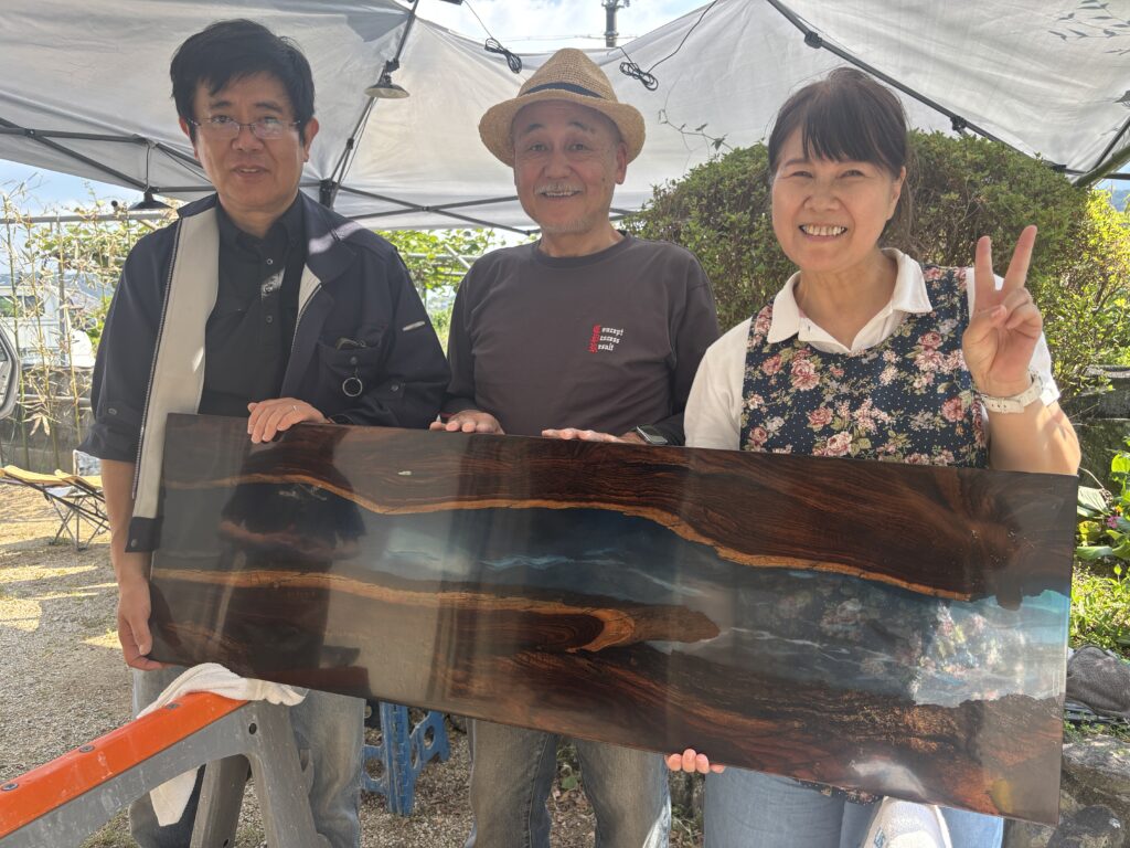 完成したパリサンダーのレジンテーブルを囲む制作体験参加者